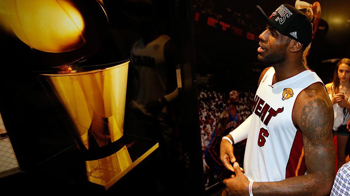 Prominent game-used collector holding jerseys in Heat case